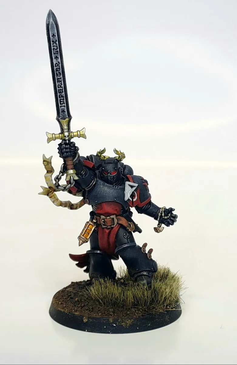 Painted armoured knight miniature raising a greatsword