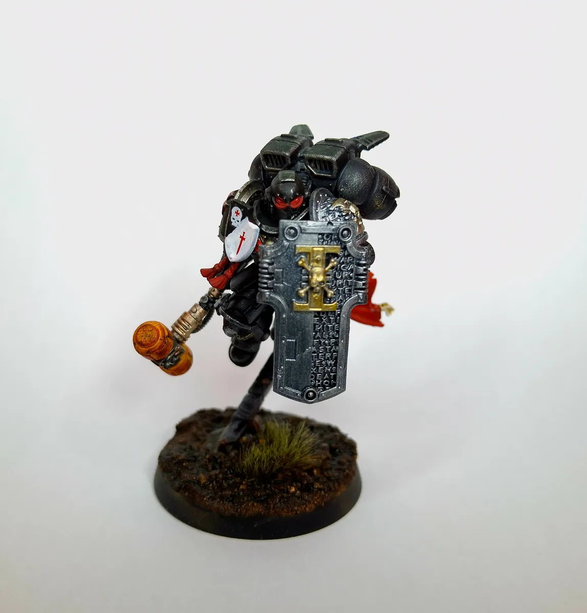 Painted black-armoured warrior miniature with hammer and tower shield