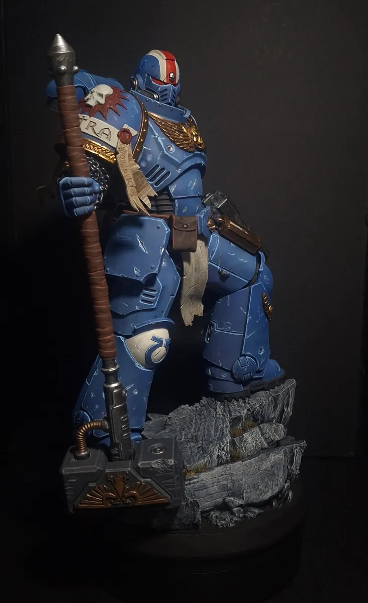 Painted blue-armoured captain miniature with spear on a rocky base
