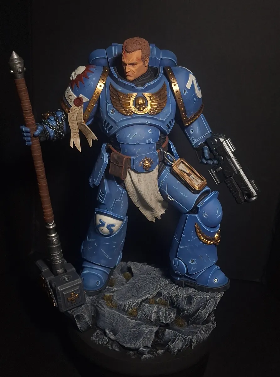 Close view of the blue-armoured captain miniature showing face and armour detail