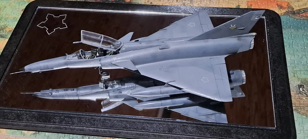 Unpainted high-detail resin prints of a jet aircraft on the build plate